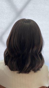 Back view of the dark brown Fortune wig with soft waves