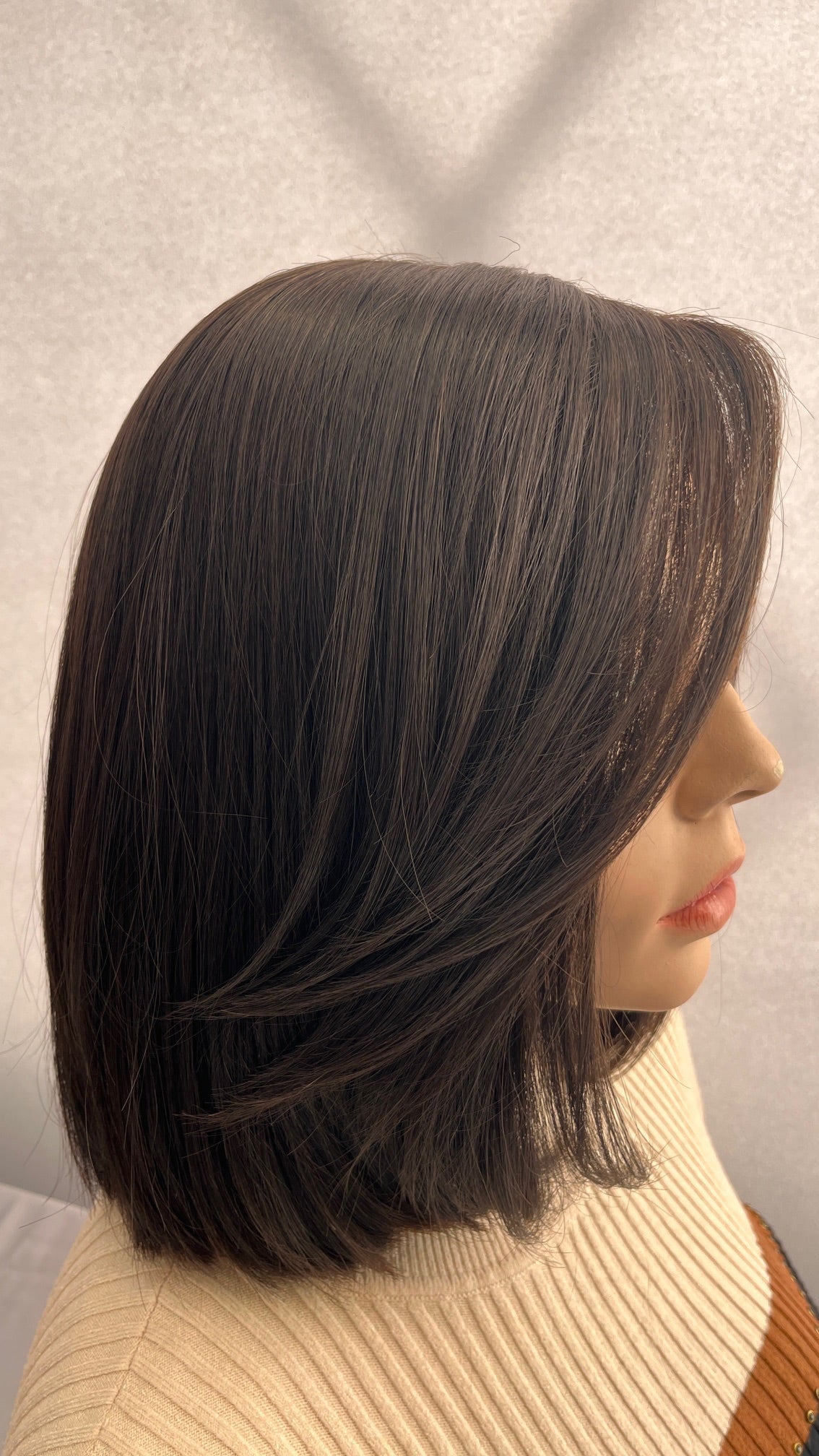 Side view of the Fortune wig's straight style and turned-under ends