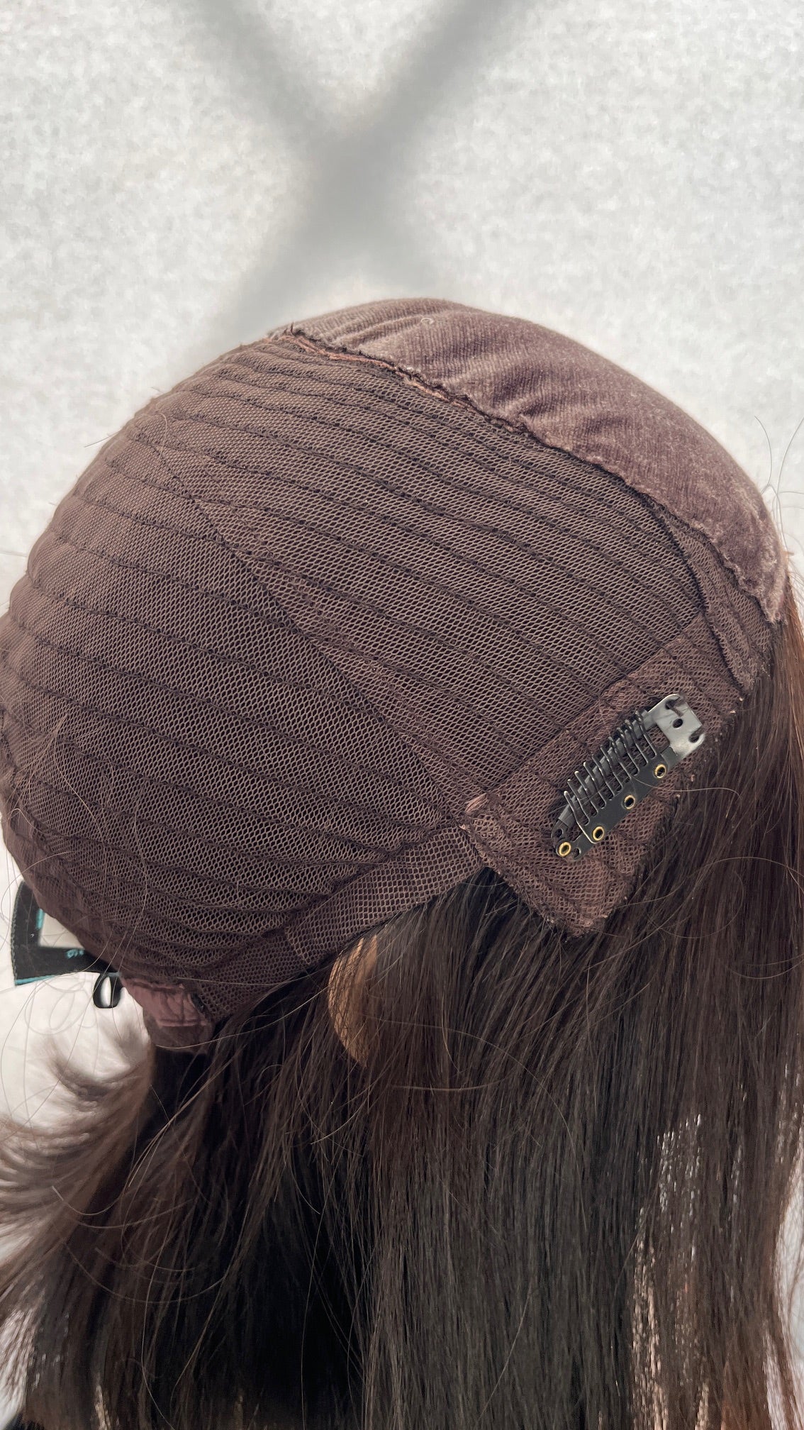 Inside side view of the Fortune wig's mesh cap and clip
