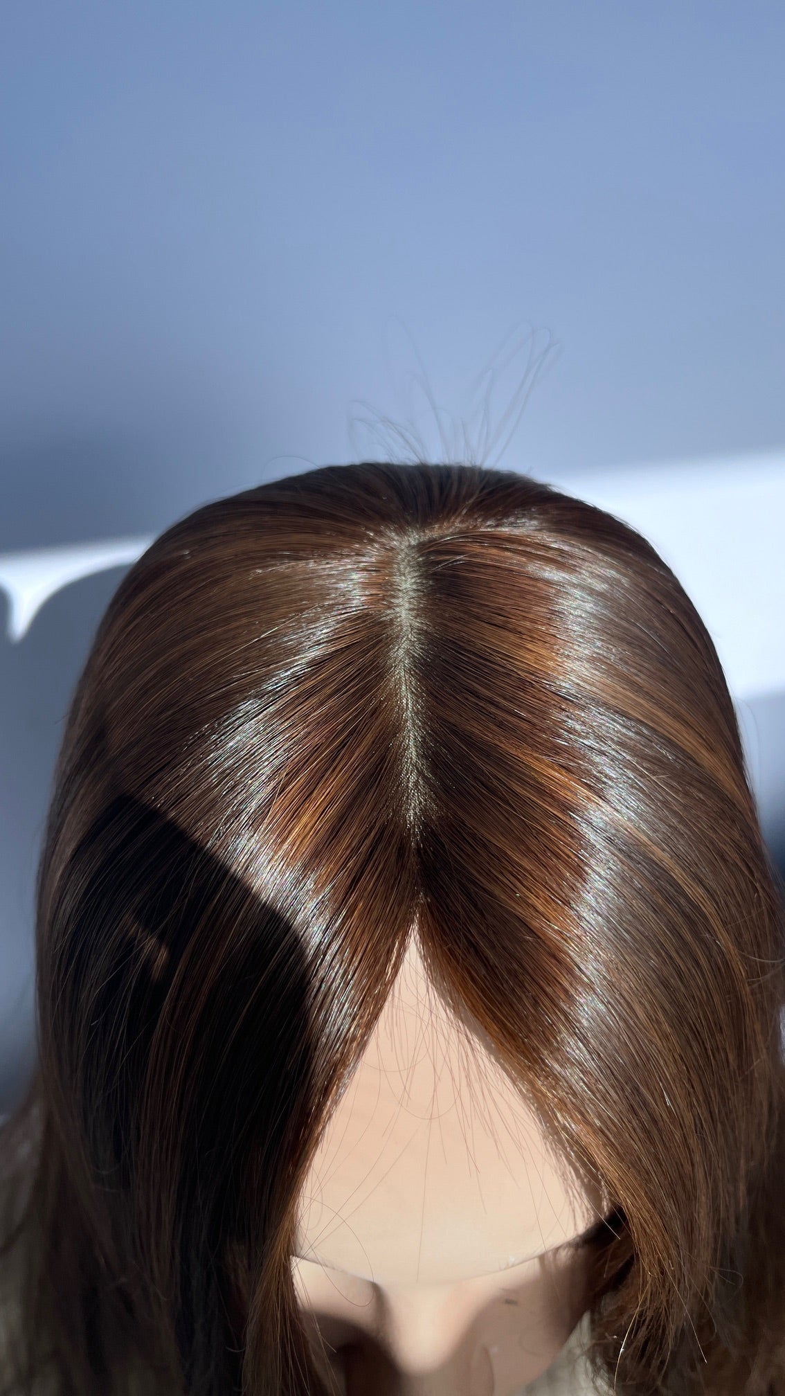 Top view of the Shevy wig showing the part and crown.