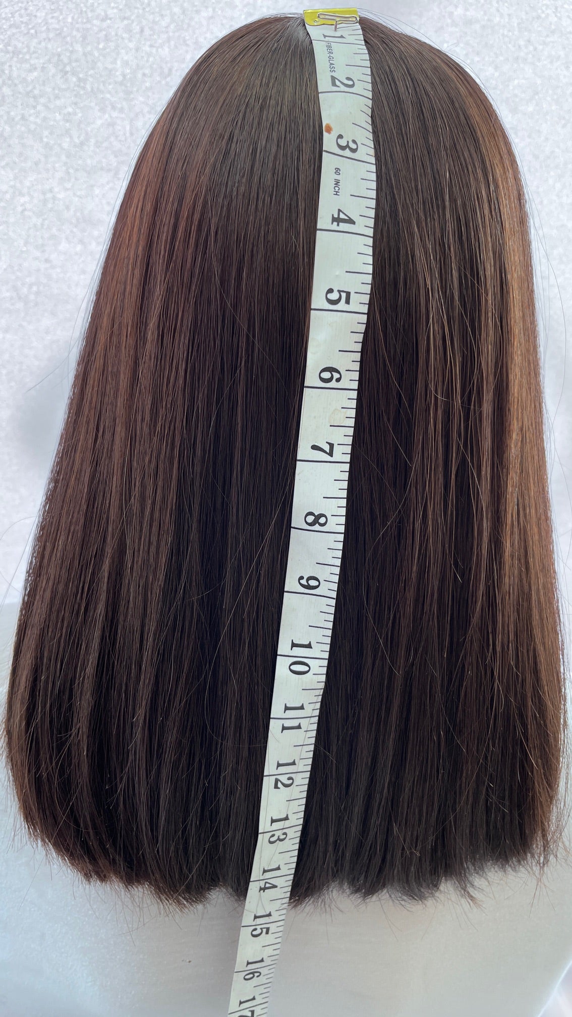 Pre-owned Mazali wig, back view with a measuring tape.
