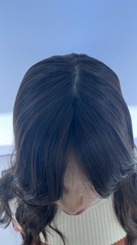 Top view of the Sari Luxe wig showing the part and crown.