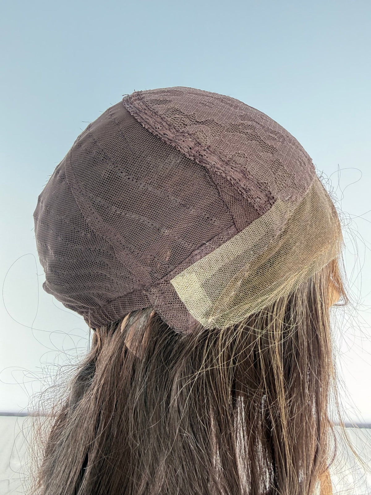 Inside of the Tuni wig cap, side view showing the front edge.
