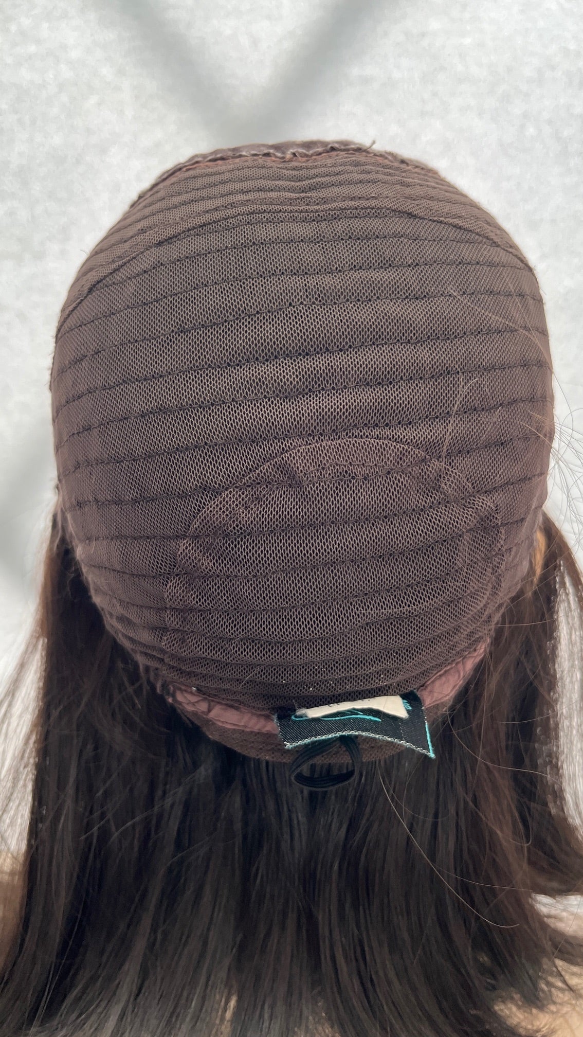 Inside back view of the Fortune wig's mesh cap and sewn label
