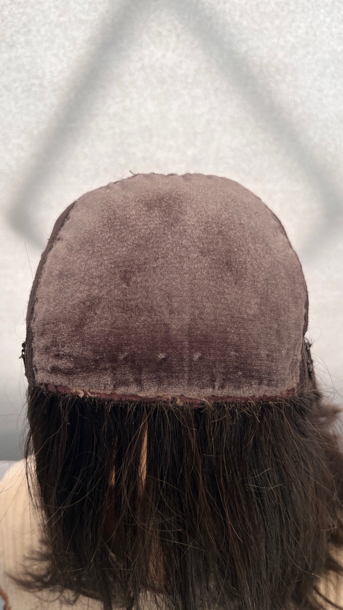 Inside front view of the Fortune wig's silk panel, showing surface pilling and edge wear