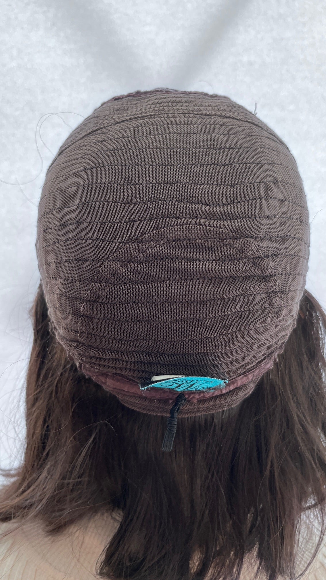Inside back view of the Fortune wig's mesh cap and sewn label