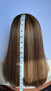 Pre-owned Irene wig, back view with a measuring tape.