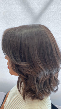 Opposite-side view of the Fortune wig's layered cut and soft waves