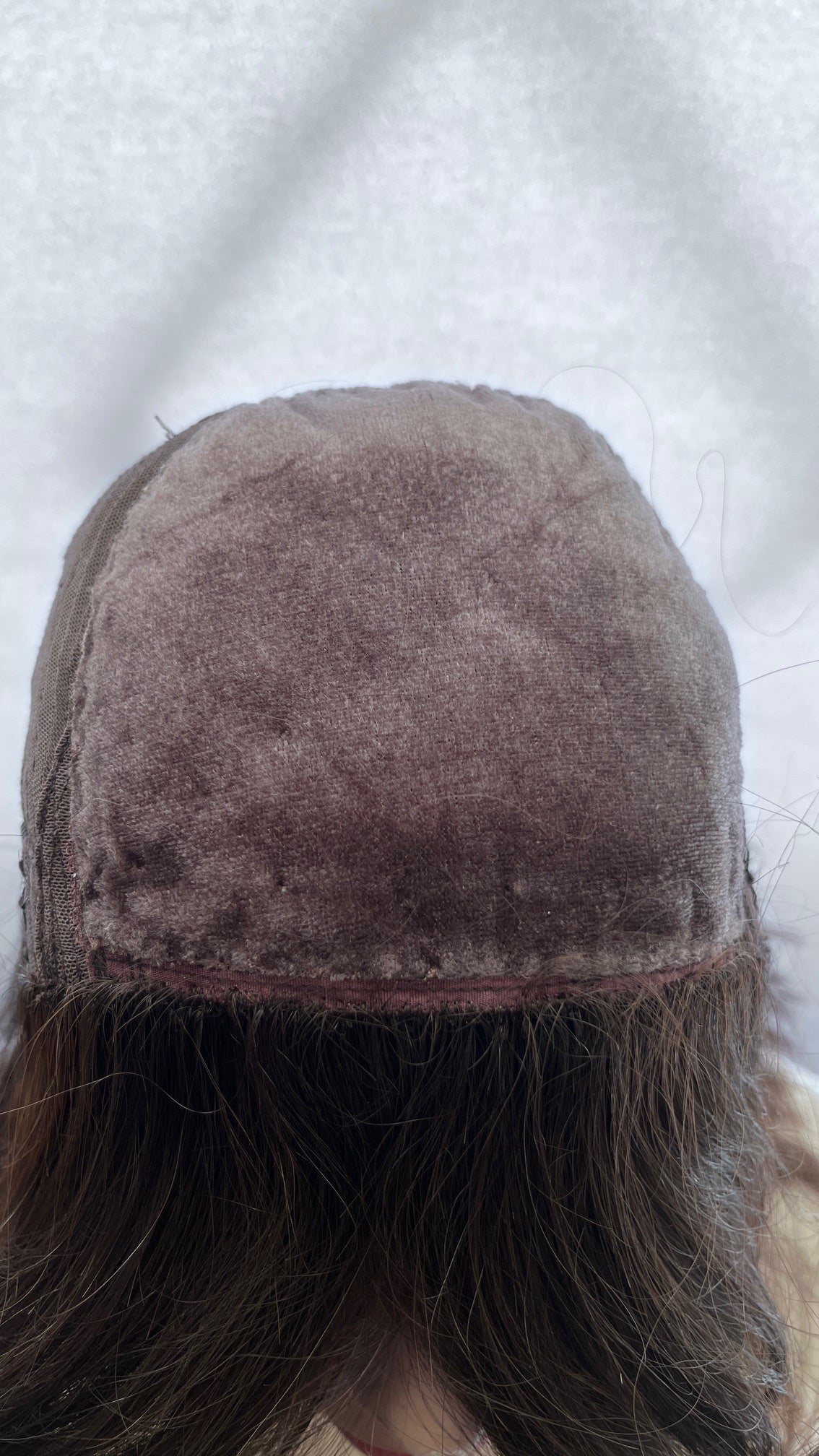 Inside front view of the Fortune wig's silk panel, showing surface pilling and edge wear