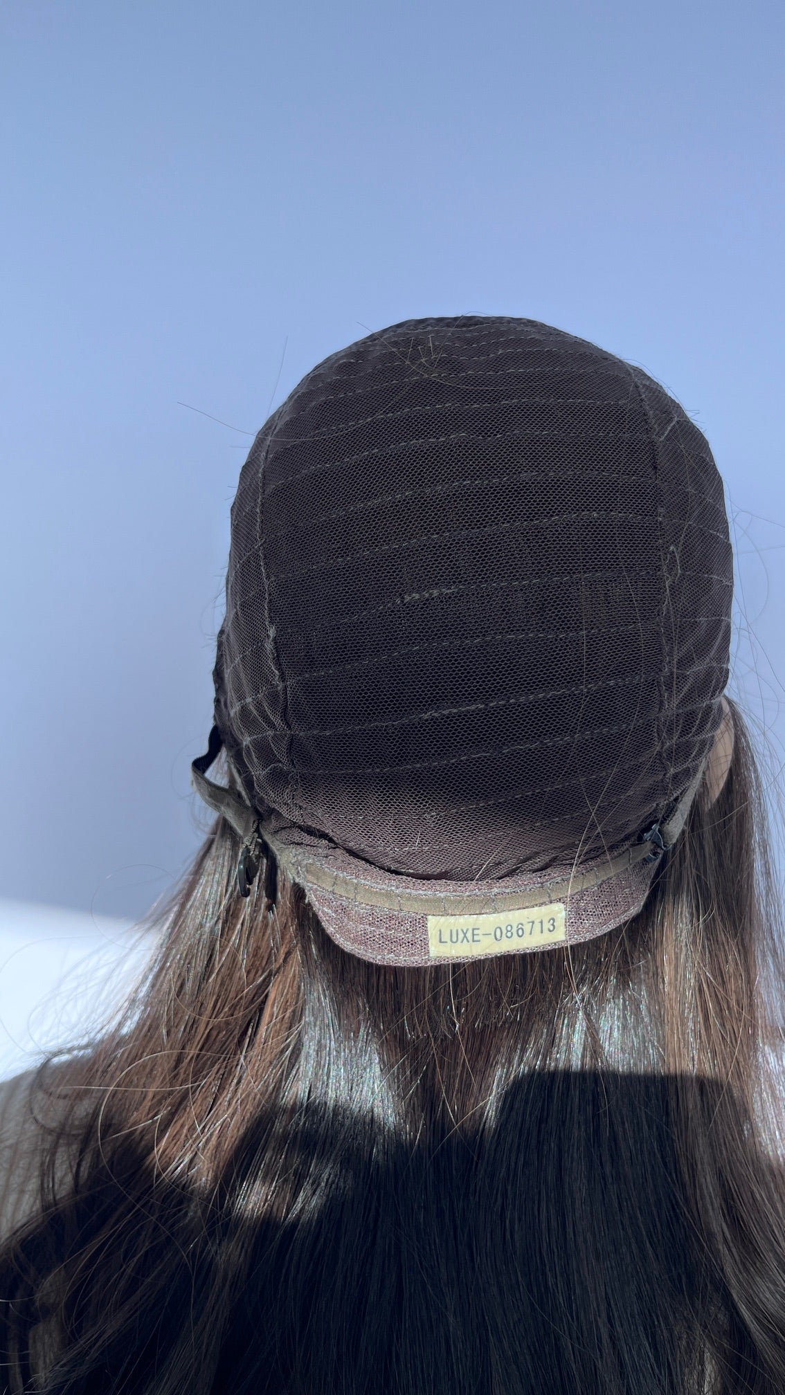Inside back of the Sari Luxe wig cap showing its sewn label.