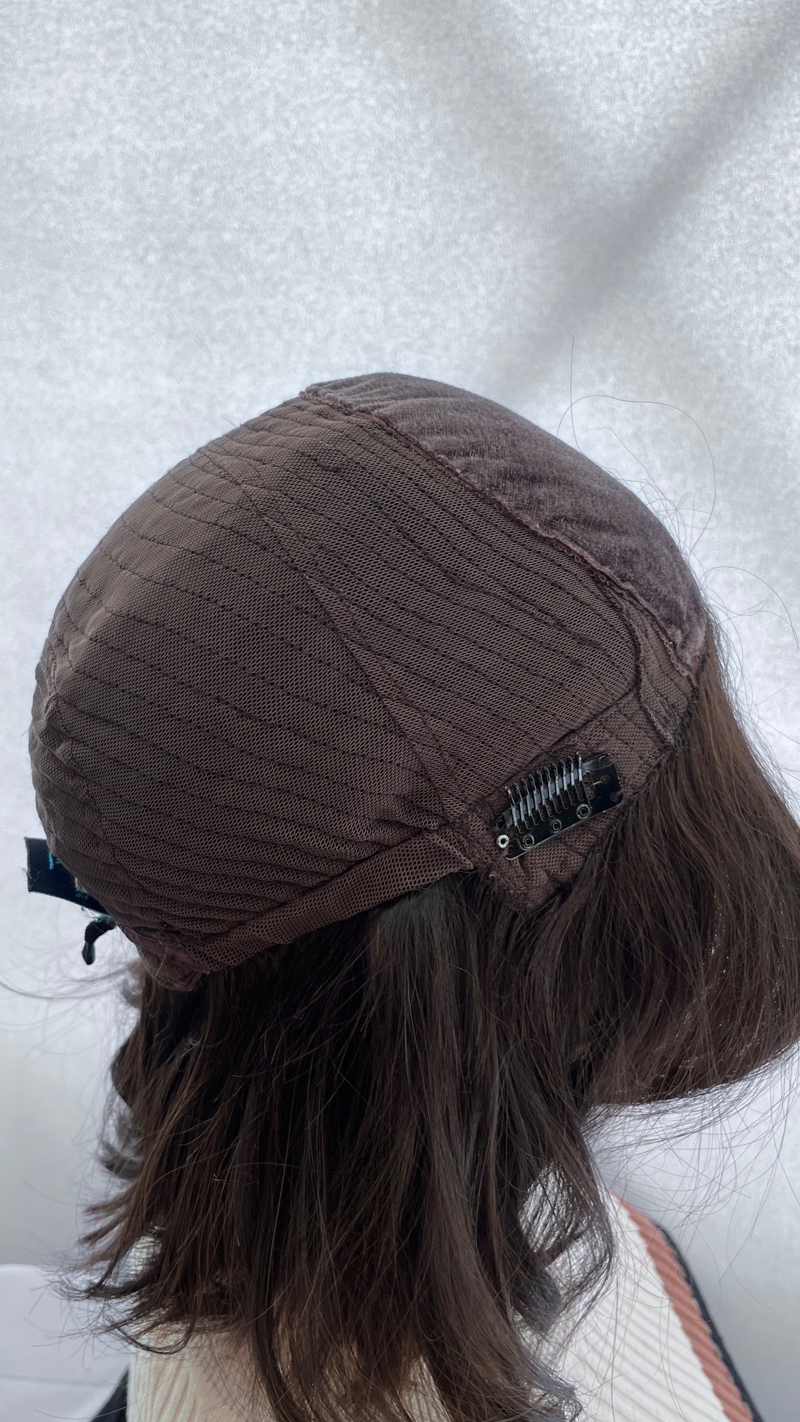 Inside side view of the Fortune wig's mesh cap and clip