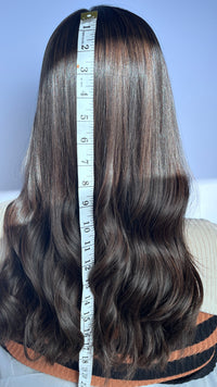 Back of the Sari Luxe wig with a measuring tape beside the hair.
