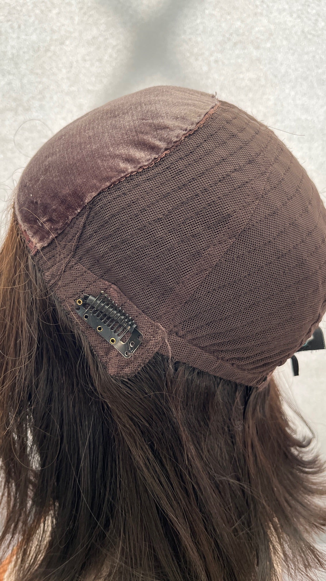 Opposite inside view of the Fortune wig's cap and clip