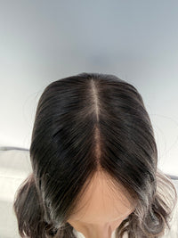 Top view of the Tuni wig showing its part and front hairline.