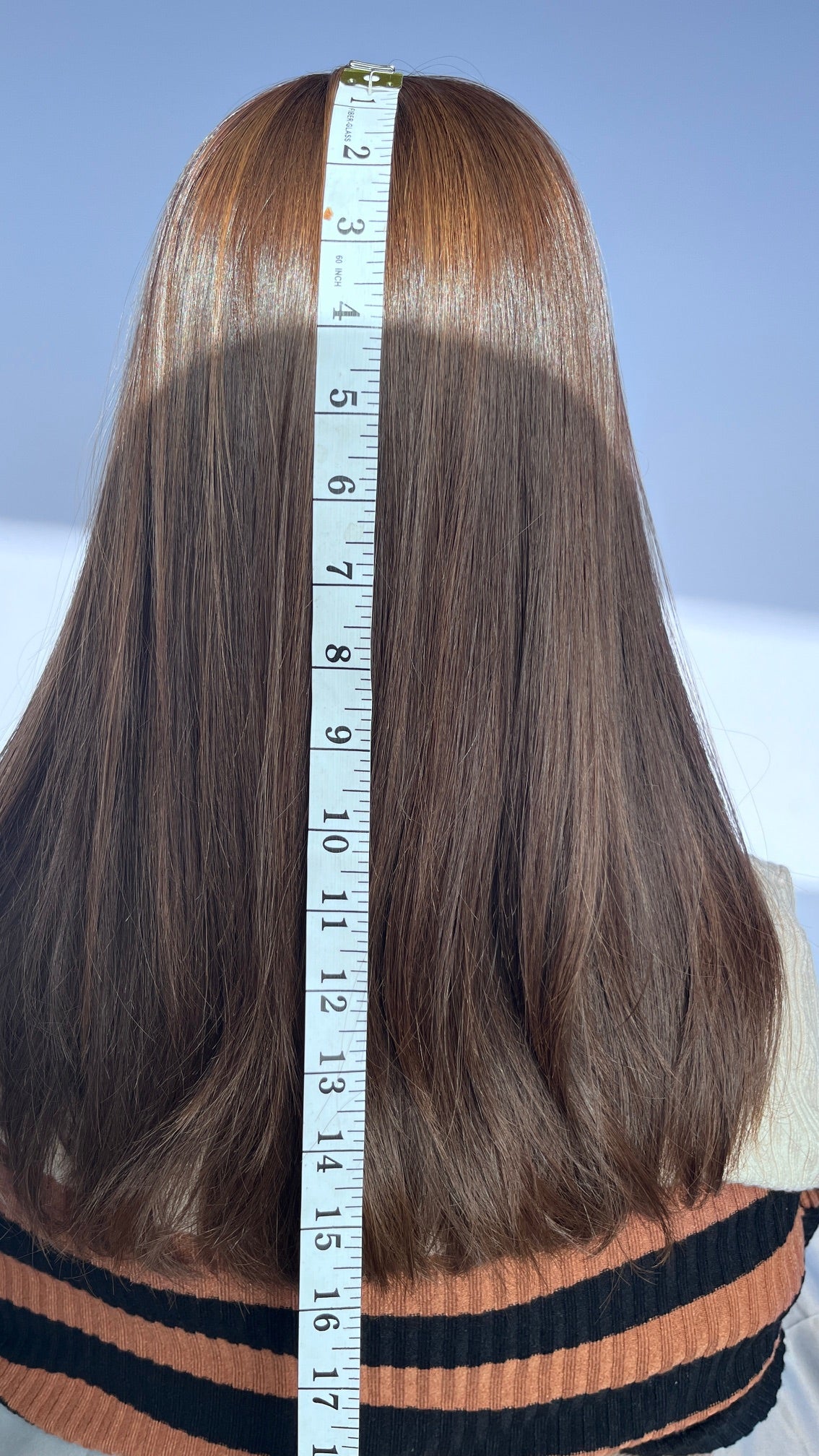 Back of the Shevy wig with a measuring tape beside the hair.